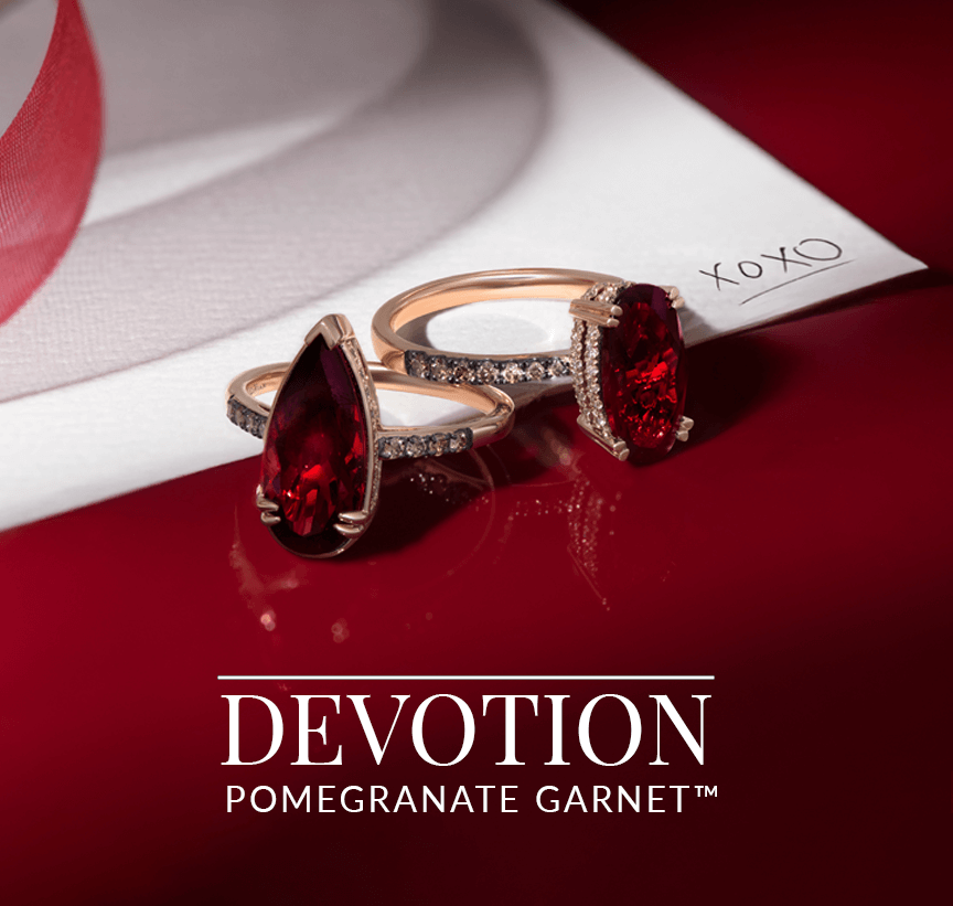 Passion-red pomegranate garnet rings set in rose gold and accented with pavé diamonds, paired with a romantic note and ribbon, from Le Vian’s Devotion collection.
