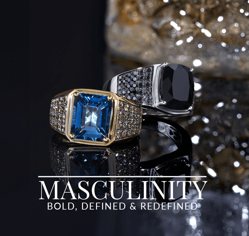 Two bold men’s rings—one with a rectangular blue gemstone and the other with a black gemstone and black pavé diamonds—against a dark, masculine backdrop.