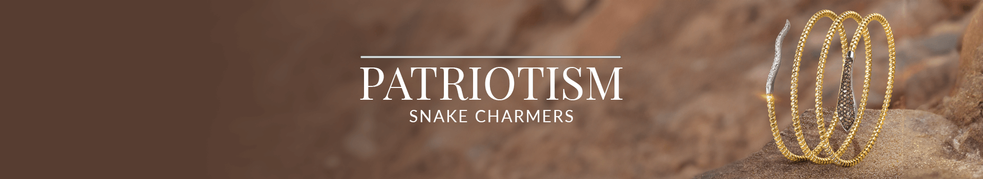 Gold wrap-around bracelet with snakehead and tail details, encrusted with diamonds, coiled on desert rock, from Le Vian’s Patriotism Snake Charmers collection.