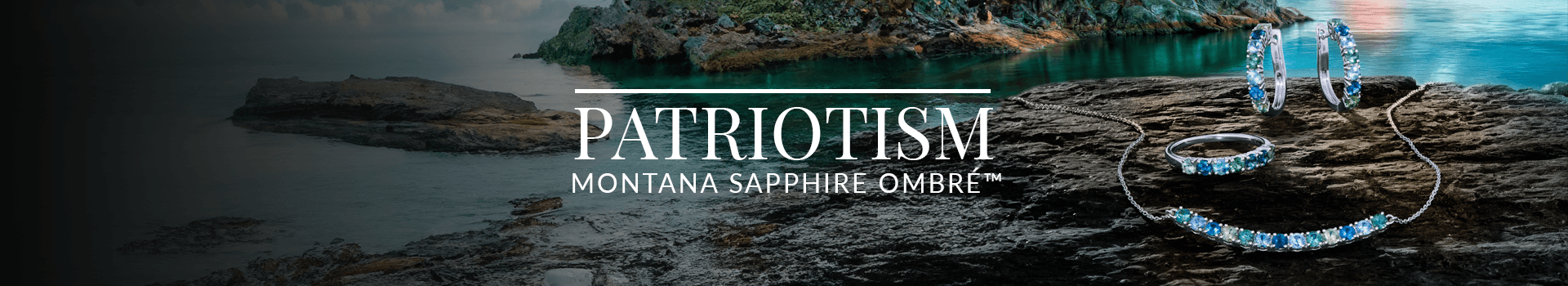 Necklace, earrings, and ring set with Montana Sapphire Ombré™ gemstones resting on rugged rock by a tranquil body of water, from Le Vian’s Patriotism collection.