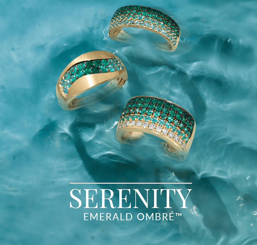 Three gold rings with vibrant green emerald ombré pavé detailing floating on serene water, from Le Vian’s Serenity Emerald Ombré™ collection.