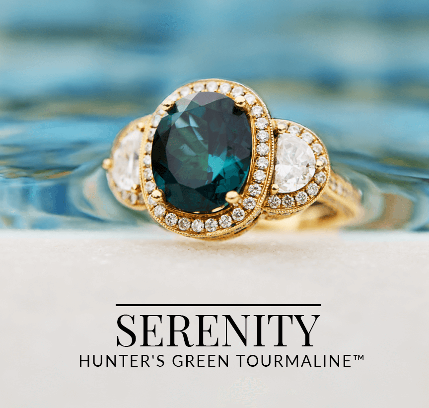 Regal gold ring with an oval Hunter’s Green Tourmaline™ gemstone flanked by diamonds, set against a softly rippling water background from Le Vian’s Serenity collection.