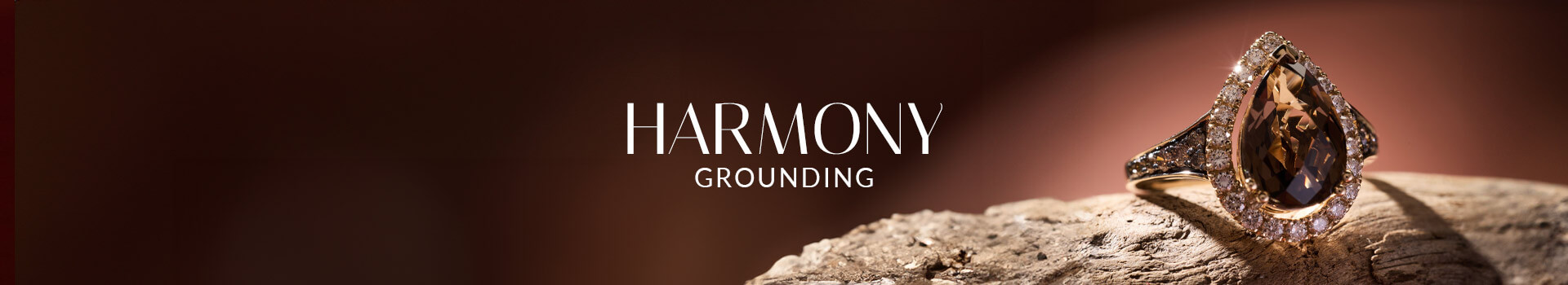 Le Vian® pear-shape brown gemstone ring with diamond halo on natural wood, inspired by grounding earth tones.