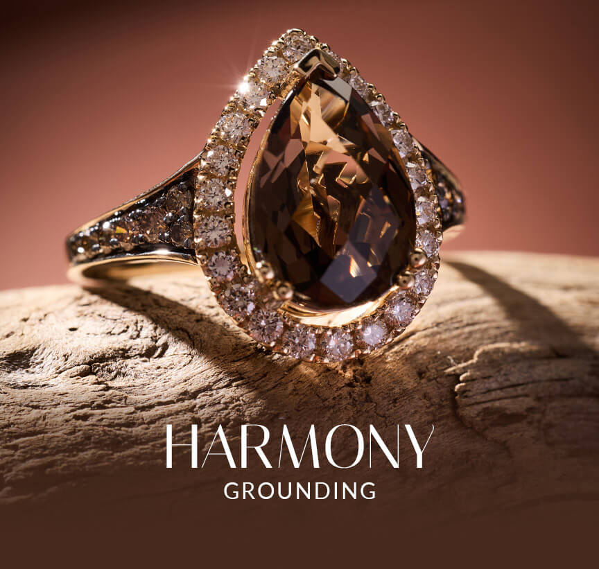 Le Vian® pear-shape brown gemstone ring with diamond halo on natural wood, inspired by grounding earth tones.