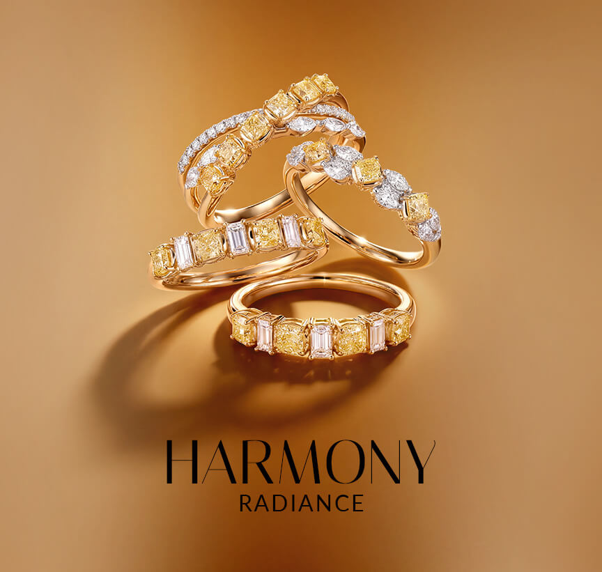 Le Vian® yellow diamond rings with white diamond accents on a warm golden background.