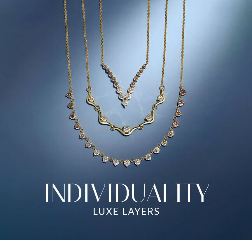Layered Le Vian® necklaces with graduated diamond accents displayed against a deep blue background.