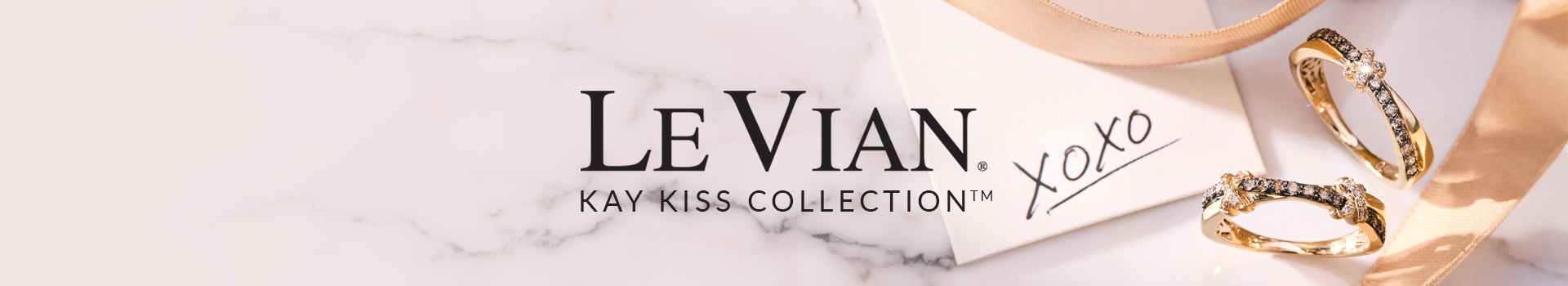 A Le Vian Kay Kiss Ring with Vanilla Diamonds, Chocolate Diamonds, and Yellow Gold, part of a jewelry collection.
